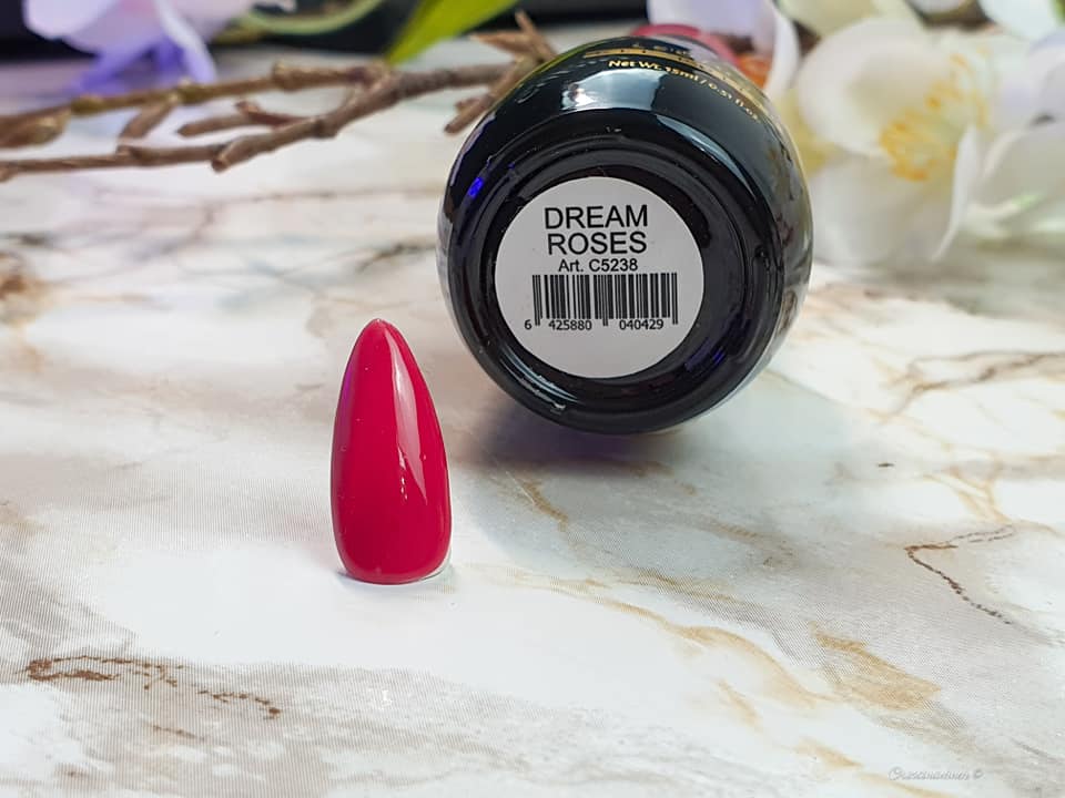 Nagelspitze in Pink neben einer Flasche Dream Roses Nagellack