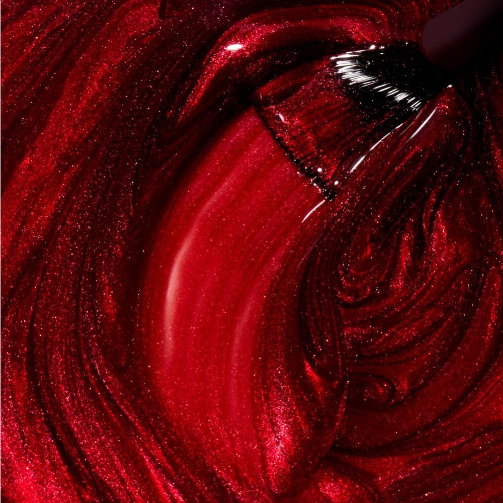 Nahaufnahme von glitzerndem roten Nagellack mit Pinsel